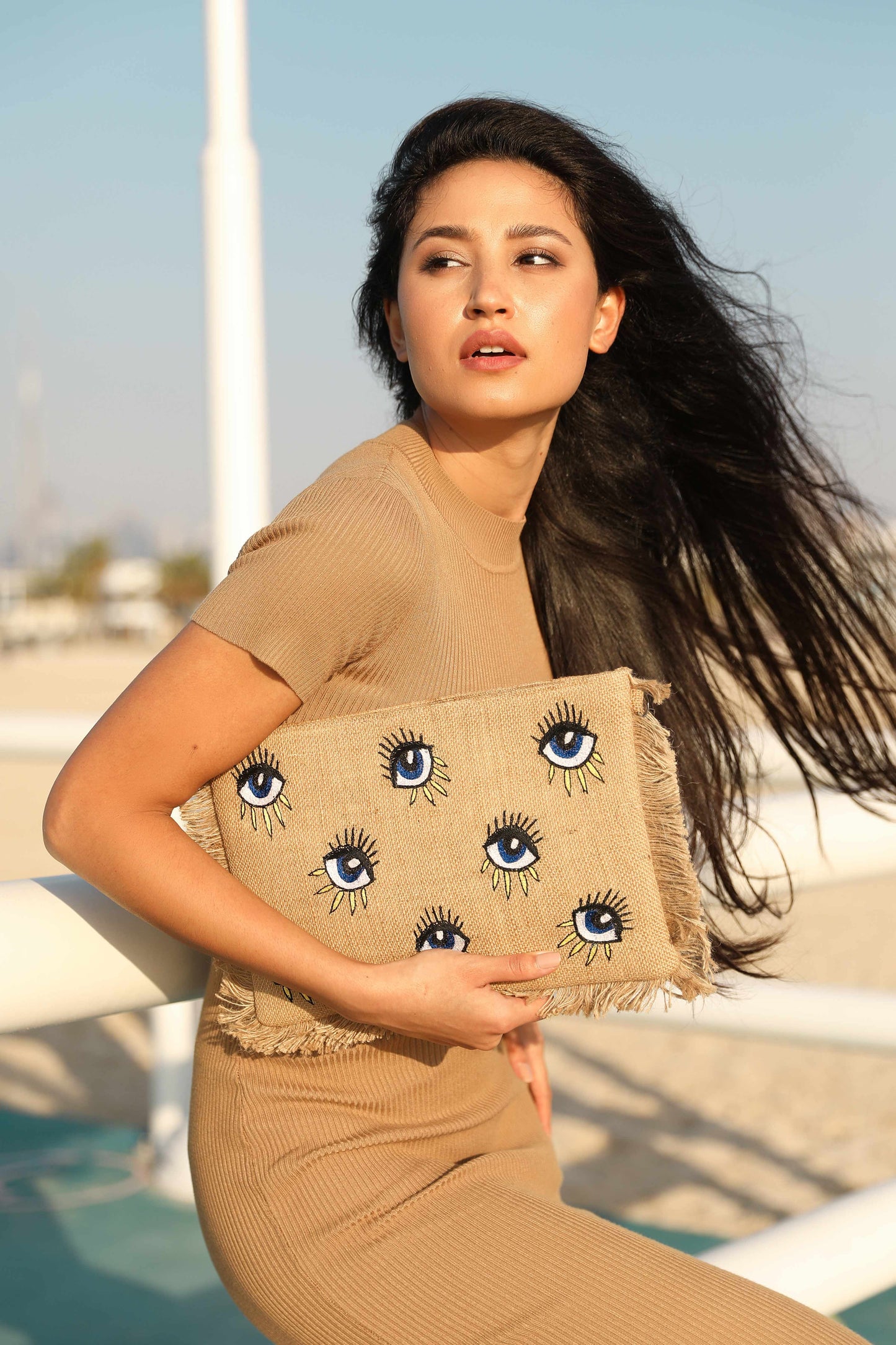 Evil eye design sling clutch