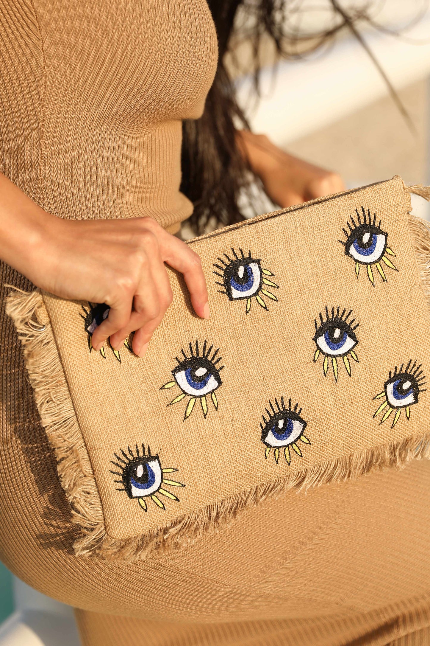 Evil eye design sling clutch