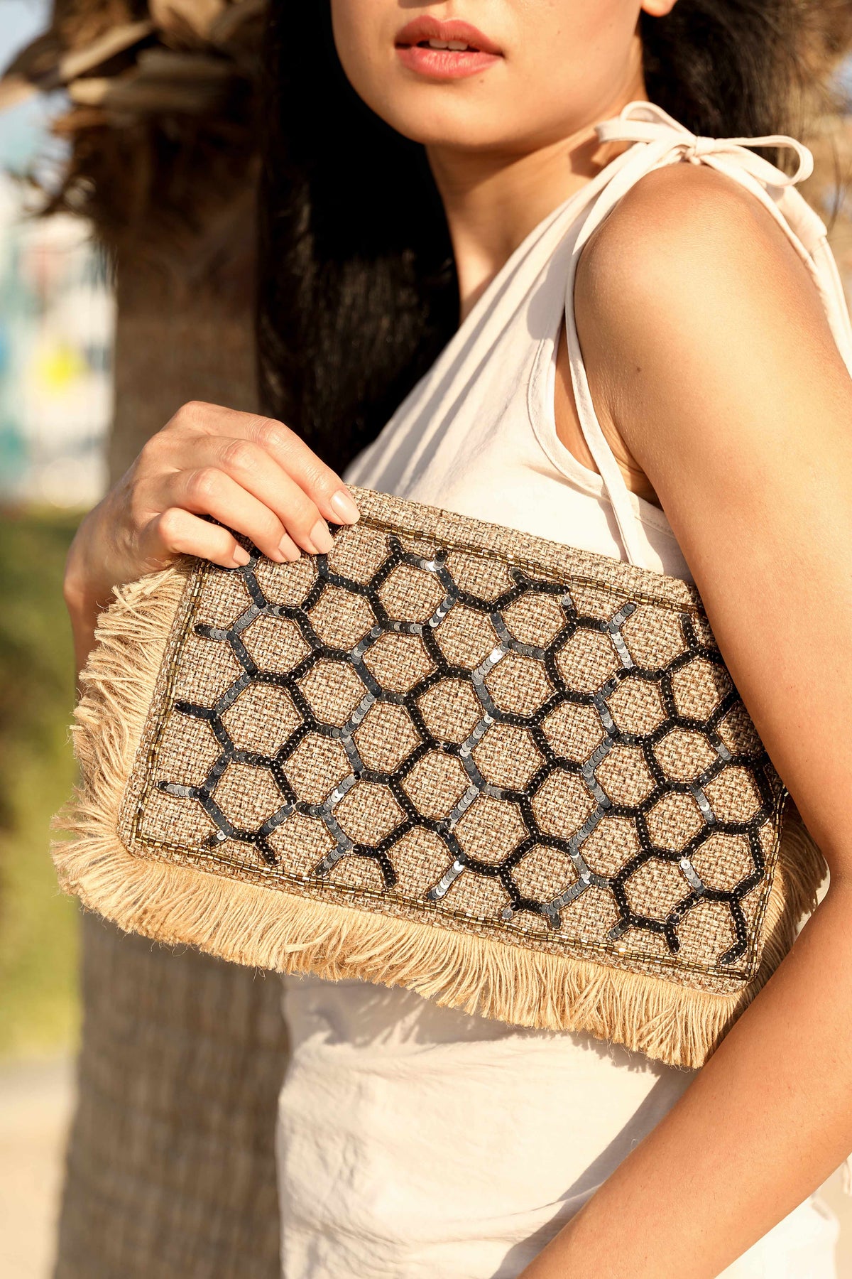 Honeycomb design clutch with a sling