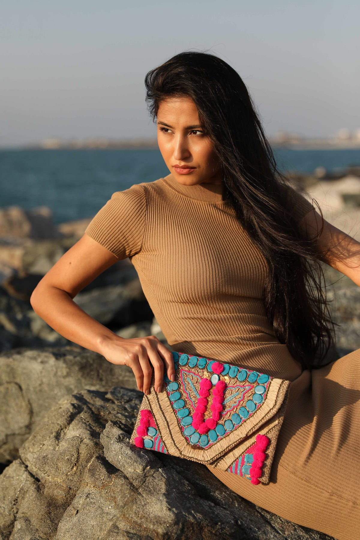 Pink pompom & blue stone clutch with a sling